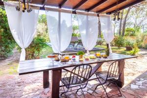 a picnic table with food and drinks on a patio at Villa Pinewood in Santa Margherita di Pula