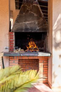 a brick oven with a fire inside of it at Villa Pinewood in Santa Margherita di Pula
