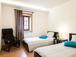 a bedroom with two beds and a chair and a window at Cerca dos Passais in Entre Ambos os Rios +50 photos