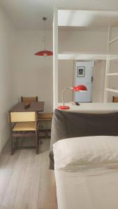 a bedroom with a bed and a desk with a lamp at Casa AL CORSO Pozzuoli Centro in Pozzuoli