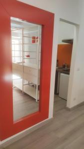 a mirror with a red frame in a room at Casa AL CORSO Pozzuoli Centro in Pozzuoli