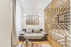 a living room with a bed and a staircase at Zeus Design Apartments Schönbrunn in Vienna