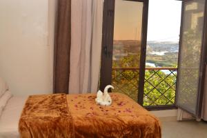 a bedroom with a bed with a swan on it at ASWAN NILE PALACE (swimming pool-rooftop-Nile view) in Aswan