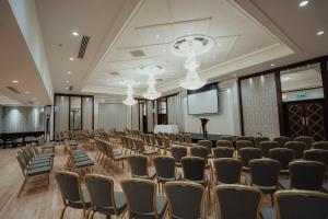 a room with rows of chairs and a screen at Dunadry Hotel And Gardens in Antrim +103 photos