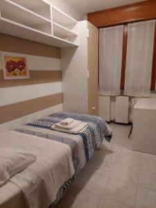 Lova arba lovos apgyvendinimo įstaigoje Casa di Mario e Natalina