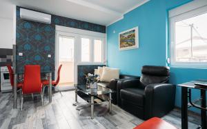 a living room with a couch and a table at Mici Luxury Apartments in Ledine