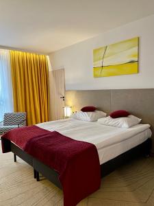 a bedroom with a large bed with a red blanket at Arche Hotel Krakowska in Warsaw +68 photos