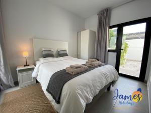 sypialnia z dużym łóżkiem i ręcznikami na nim w obiekcie Luxurious Villa Private Pool La Marina Urb LM3 w mieście San Fulgencio +16 zdjęć