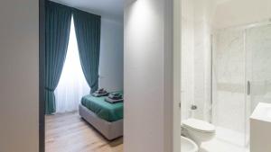 a bathroom with a bed and a toilet and a shower at Cavour 82 in Florence