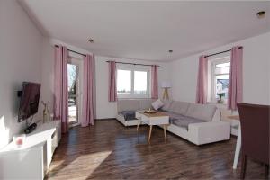 a living room with a couch and a table at Wohlfühloase in Eisenbach