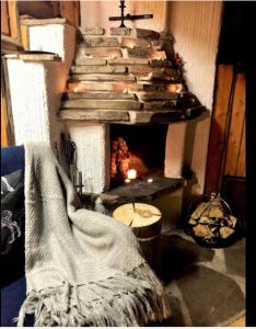 a living room with a fireplace with a blanket at Lapland Tunturimaja Ski in, sauna, in Pyhä center - Lapland Villas in Pyhätunturi