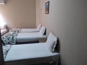 A bed or beds in a room at Fronteira Hotel