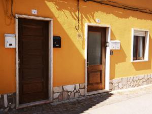 two doors on the side of a building at Family Surf Home - Casa do Sol in Mafra