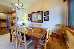a dining room with a wooden table and chairs at Antlers in Steamboat Springs