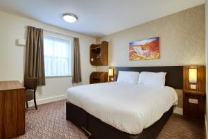 a hotel room with a bed and a desk at Highland Gate, Stirling by Marston's Inns in Stirling
