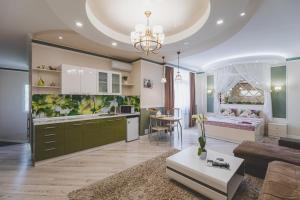 a living room with a kitchen and a bedroom at Апартаменты в гостевом домике in Almaty