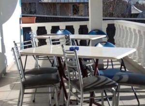 a group of tables and chairs on a roof at Pensiunea Ursulet in Alexandru cel Bun