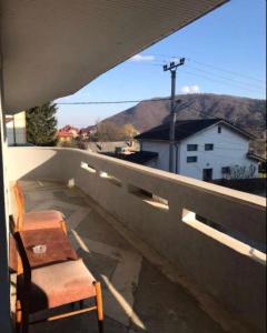 a chair sitting on the ledge of a balcony at Pensiunea Ursulet in Alexandru cel Bun