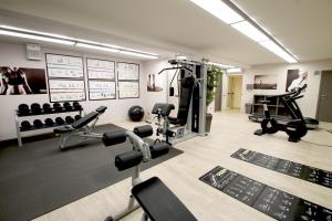a gym with treadmills and machines in a room at Hotel Villa Tirreno in Tarquinia