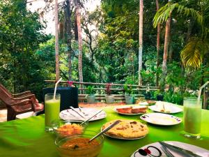 a green table with food and drinks on it at Ella Walkers Nest in Ella