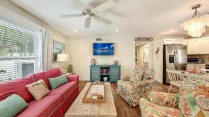 a living room with a red couch and a fireplace at Canal Lower-Gorgeous 3 bed 3 bath near SK Village in Siesta Key