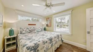 a bedroom with a bed and a ceiling fan at Canal Lower-Gorgeous 3 bed 3 bath near SK Village in Siesta Key +36 photos