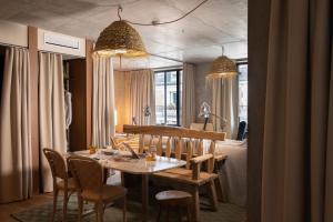 a dining room with a wooden table and chairs at MOB House in Saint-Ouen