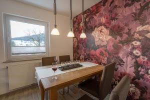 a dining room with a table with glasses of wine at Ferienwohnungen Alpentraum - Alpentraum in Obermaiselstein