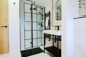 a bathroom with a glass shower and a sink at Host & Stay - Iris Cottage in Pickering