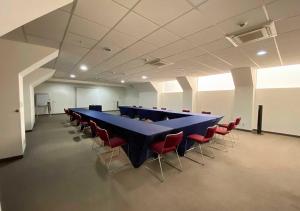 a long blue table and chairs in a room at Hotel MX forum buenavista CDMX, Trademark by Wyndham in Mexico City