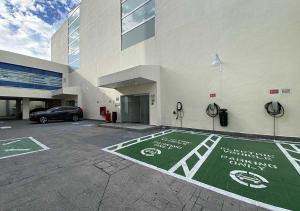 a parking lot in front of a building with a car at Hotel MX forum buenavista CDMX, Trademark by Wyndham in Mexico City