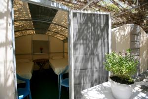 a doorway into a tent with a table and a potted plant at Camping Koula in Parikia