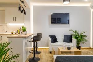 a living room with a couch and a table at Sandra's luxury studio apartment in Tolo