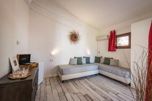 a living room with a couch and a tv at Tiliguerta Glamping&Camping Village in Costa Rei