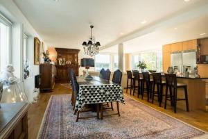 a kitchen and dining room with a table and chairs at Exclusive House in Steninge Marina , Märsta in Märsta