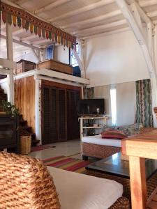 a room with a bedroom with a bed and a table at LOFT DE MONTAÑA -LaS RABONAS - PISCINA EXCLUSIVA in Las Rabonas