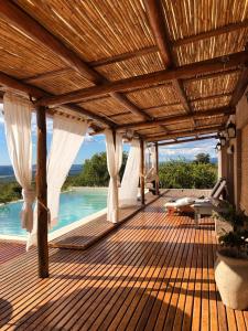 a wooden deck with a view of the water at LOFT DE MONTAÑA -LaS RABONAS - PISCINA EXCLUSIVA in Las Rabonas