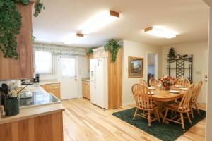 a kitchen and dining room with a table and chairs at South Fork Cabin in West Yellowstone