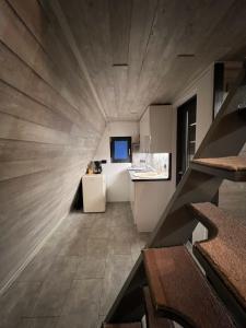 a room with a staircase leading to a kitchen at AGLAS CHALET in Moieciu de Jos