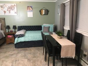 a bedroom with a bed and a table and a dining room at Home Away From Home, Recently Renovated in North Troy