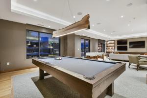 a large living room with a pool table at 3BR Residence in Canyons Village- Ski In Out in Park City