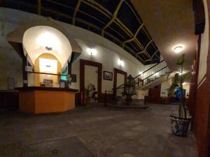 a large room with a building with an archway at Hotel Centro Historico in Puebla