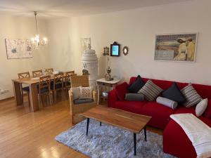 a living room with a red couch and a table at An der Marsch in Alkersum