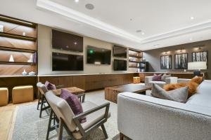 a living room with a couch and a tv at Modern 1BR Residence in Canyons VillageSki In Out in Park City