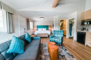 een woonkamer met een bank en een bed bij Mount Robson Inn in Jasper