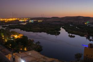 a view of a river at night at ASWAN NILE PALACE (swimming pool-rooftop-Nile view) in Aswan