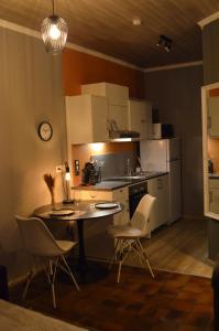 a kitchen with a table and chairs in a room at Chez Henri in Stavelot