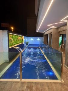 a swimming pool in a building with a large aquarium at Navega Beach Palace Hotel in Navegantes