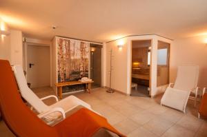 a living room with white chairs and a table at Apartments Foidl in Kitzbühel