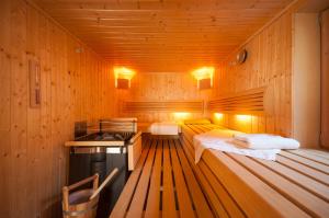 a kitchen with two beds in a wooden room at Apartments Foidl in Kitzbühel